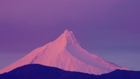 Time-lapse-of-the-sun-setting-over-the-Puntiagudo-Volcano-in-Chile,-beautiful-pink-sky