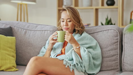 happy asian woman drinking coffee on living room