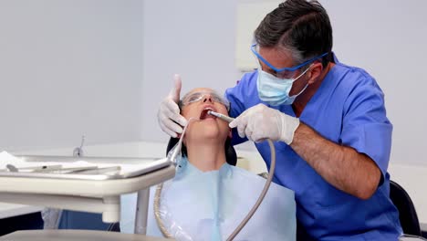 dentist using suction hose on patient