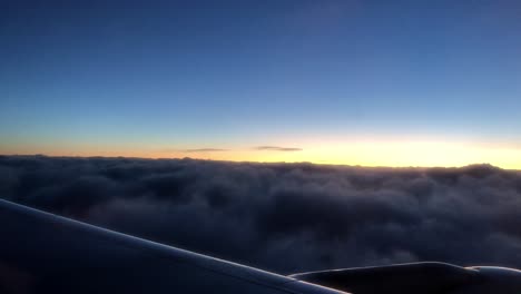 flying with a plane above clouds for travel and vacation during sunset