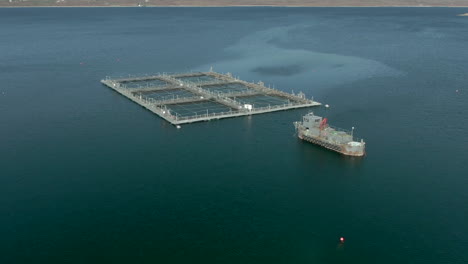 An-aerial-view-of-an-aquaculture-installation-on-Loch-Eriboll-in-the-Scottish-Highlands-on-a-sunny-day