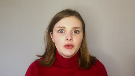 female young student listening intently whilst looking directly toward camera