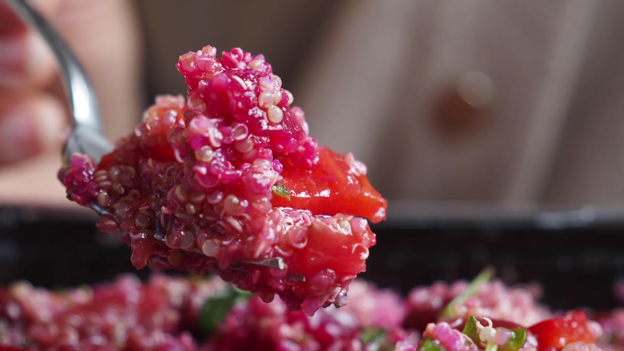 Close-up of a Forkful of Vibrant Red Quinoa Salad
