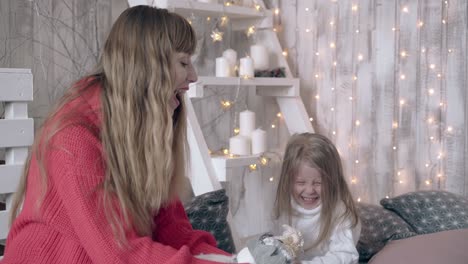 mother and daughter spend time playing with toy sheep