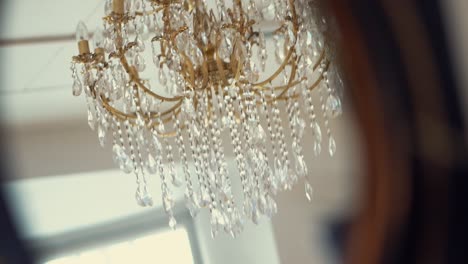 Reflection-of-beautiful-chandelier-from-mirror,-smooth-motion