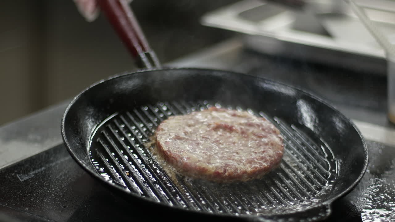 Cooking a burger patty in a pan