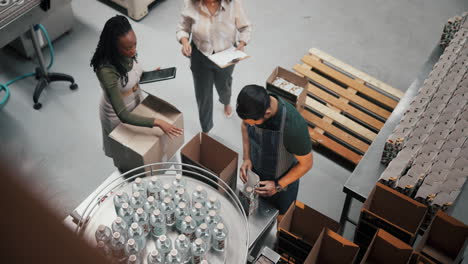 factory workers packaging beverages