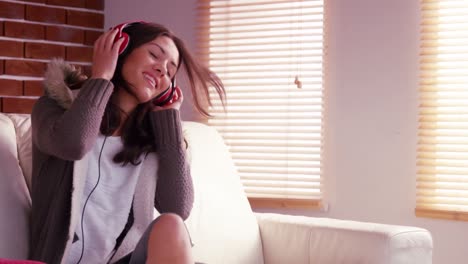 smiling woman listening to music with headphones