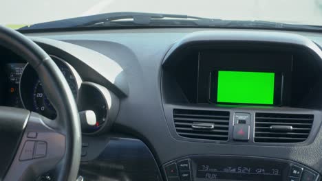 inside a car. a gps module is on. green screen