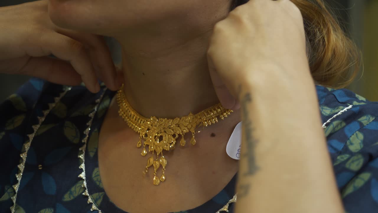 A south asian woman wearing bridal gold jewellery necklace, Closeup of neck