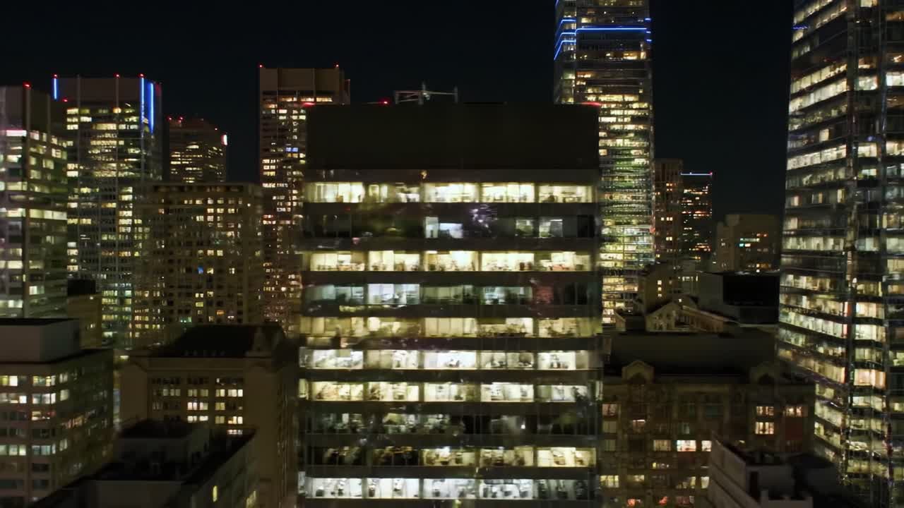 Illuminated Cityscape at Night: A Stunning View of Modern Urban Architecture and Busy Workspaces Infused with Bright Lights and Lively Energy.