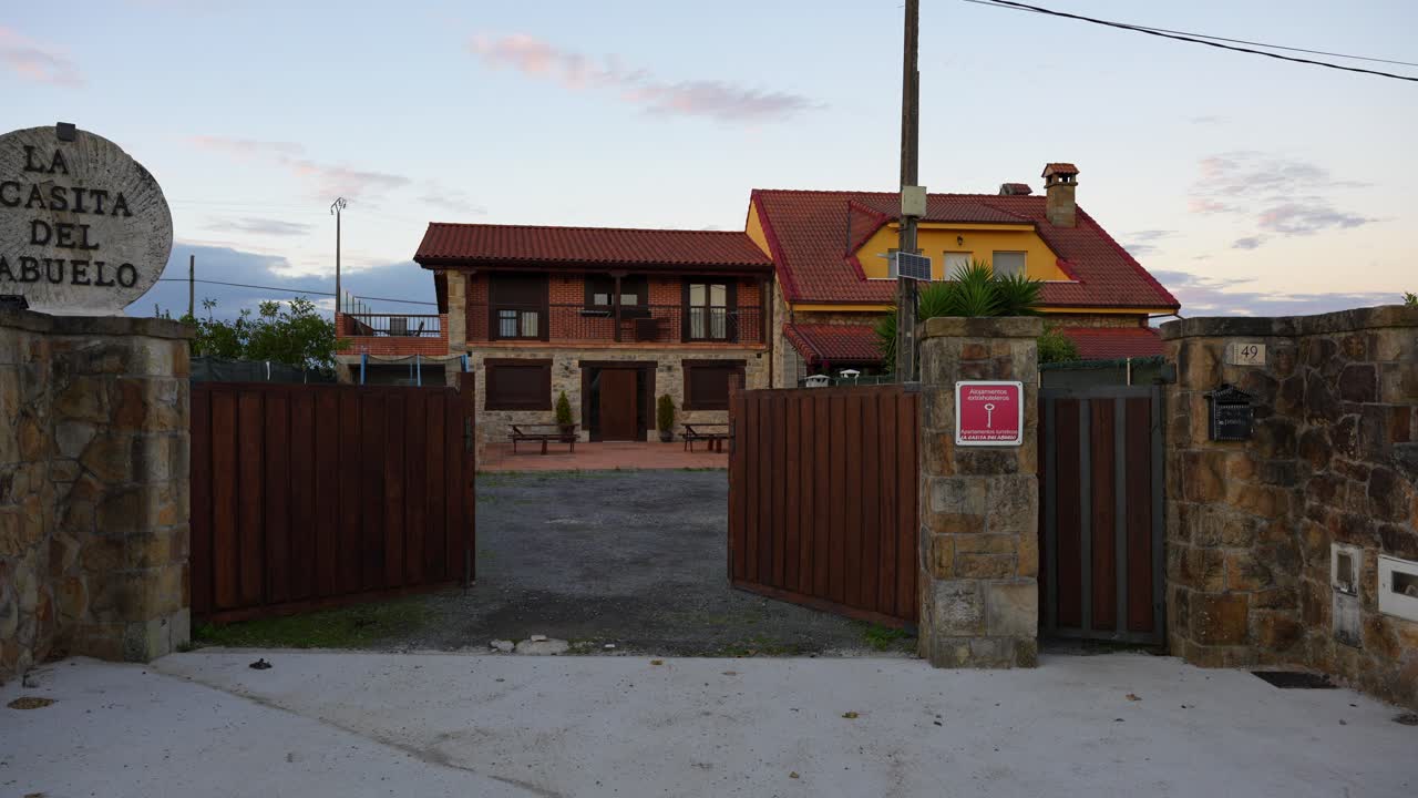Charming rural guesthouse entrance with rustic design in Galizano at dusk, Cantabria