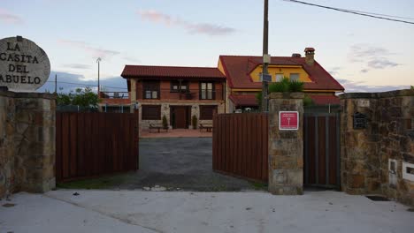 charming rural guesthouse entrance with rustic design in galizano at dusk, cantabria