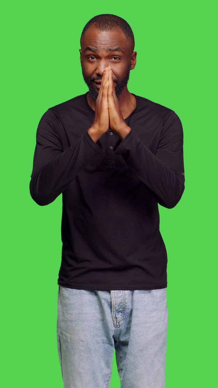 Vertical video: Front view of spiritual person praying to god in studio