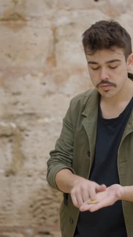 man with mustache and mullet gesturing and smiling outdoors