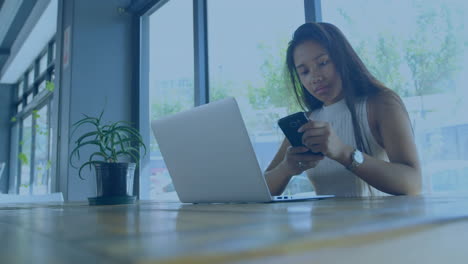 animation of scope scanning over woman using laptop and smartphone