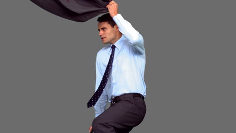 Businessman-jumping-on-grey-screen