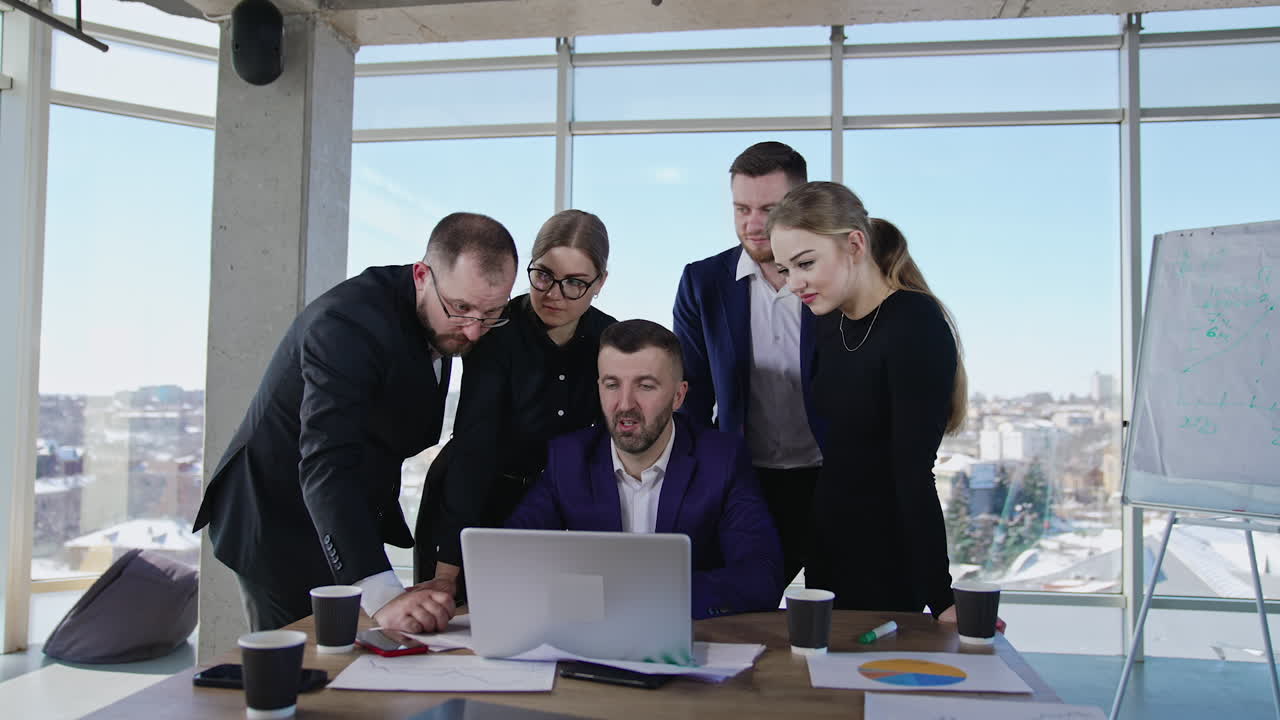 Professional business team creating ideas and making suggestions. Cooperative teamwork discuss ideas in front of laptop. Big office windows at the backdrop.