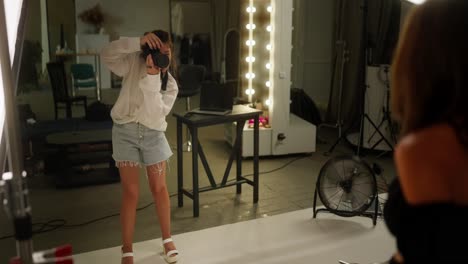 photographer taking a photo of a model in a studio