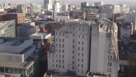 Camera-pans-down-into-city-centre-on-sunny-day-central-Manchester-UK