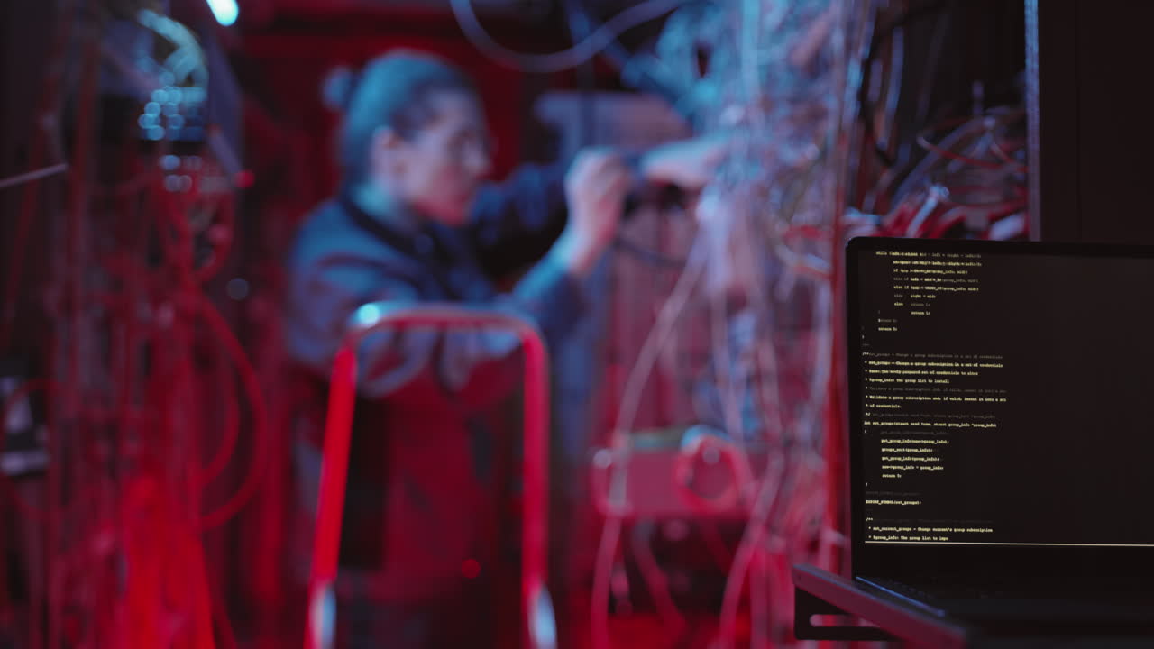 A programmer working in a server room