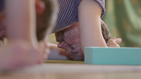 Two-concentrated-men-doing-plank-crunches-on-a-mat