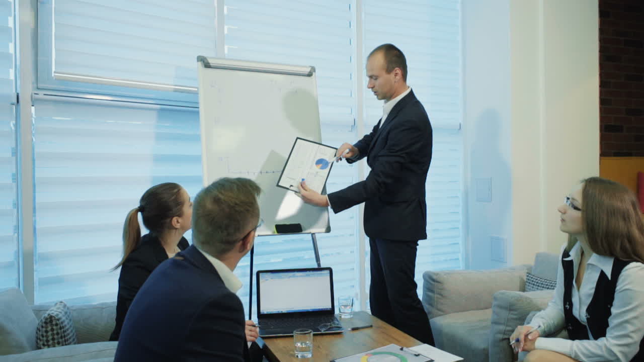 Working Process At Business Meeting. Young managers listening to his colleague explanations