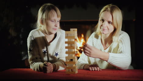 a woman with a child playing a board game where accuracy is needed