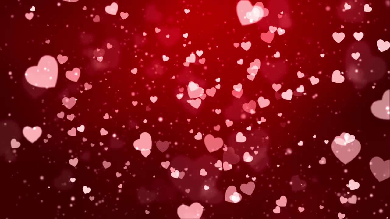 el brillo rojo brilla con luz mágica. el polvo brillante, las partículas de bokeh del corazón, el fondo de bucle 4k.