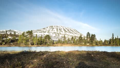 Sunrise-over-mountain-with-lake-reflection-in-front-timelapse-slider-forest-and-clouds