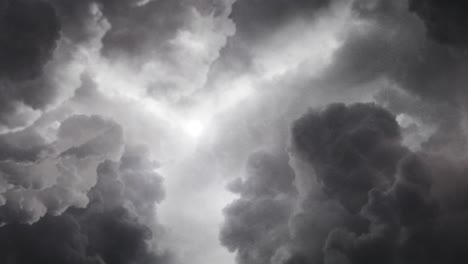 the sun shining behind the thick gray clouds of cumulonimbus