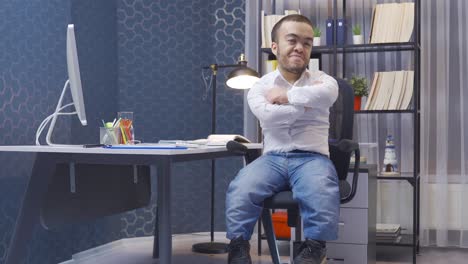 midget man working in his office turns and looks at the camera.