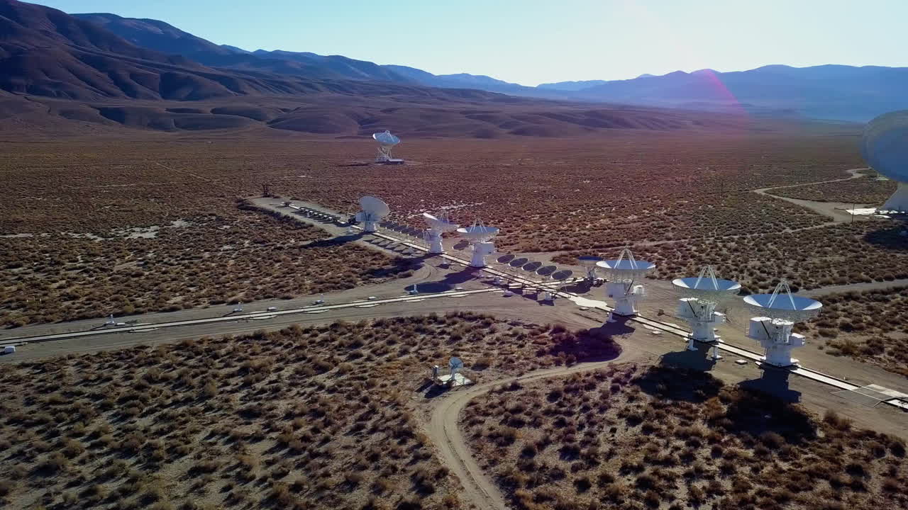 Aerial view around a space station with multiple satellite arrays, in East Sierra mountains, USA - circling, drone shot