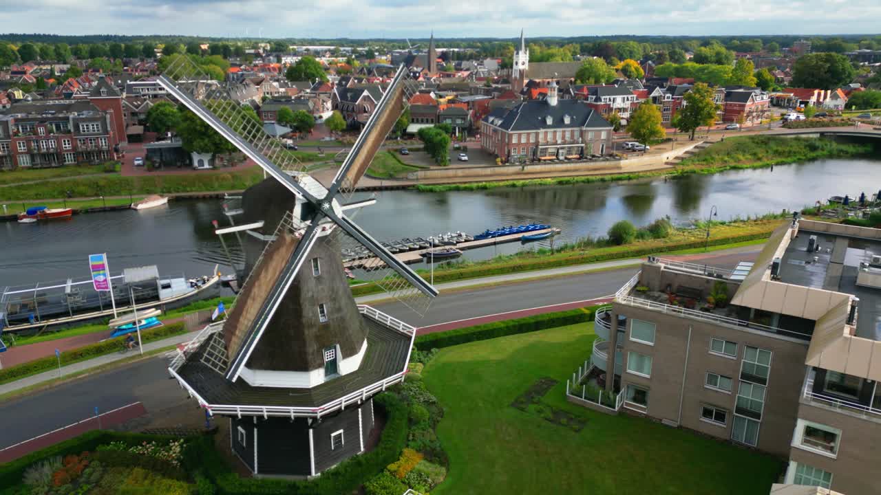 Windmill in a Town by a River