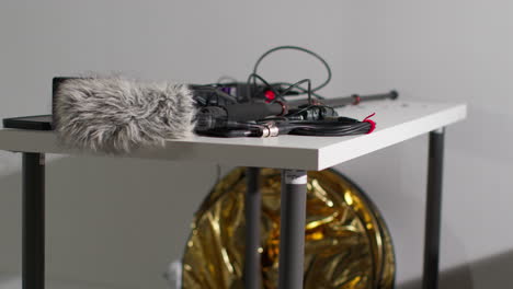 Close-Up-Of-Film-Sound-Recording-Equipment-With-Microphone-Boom-Pole-And-Wind-Muff-Shooting-Movie-Or-Video-In-Studio