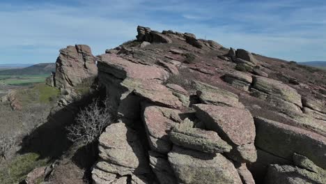 Aerial-drone-forward-view-of-an-enigmatic-red-sandstone-landscape-in-a-remote-mountainous-area-in-Guadalajara,-Spain