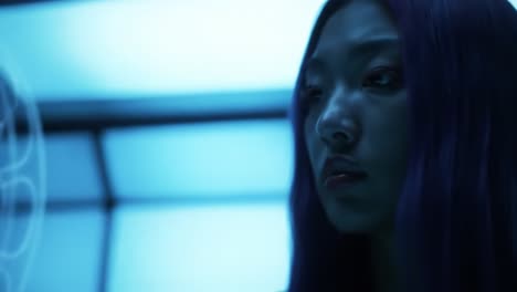 a futuristic encounter: a mysterious woman analyzes data in a high-tech environment shrouded in blue lighting, capturing a blend of science and aesthetic innovation