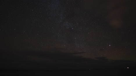 beautiful time lapse of a sky full of stars, with clouds passing through the sky