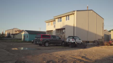 two-story house with vehicles parked in front