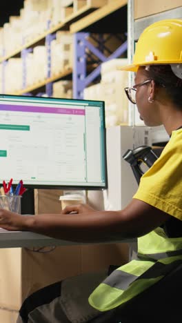 vertical video black female with hi vis vest registering awb tracking info with scanner