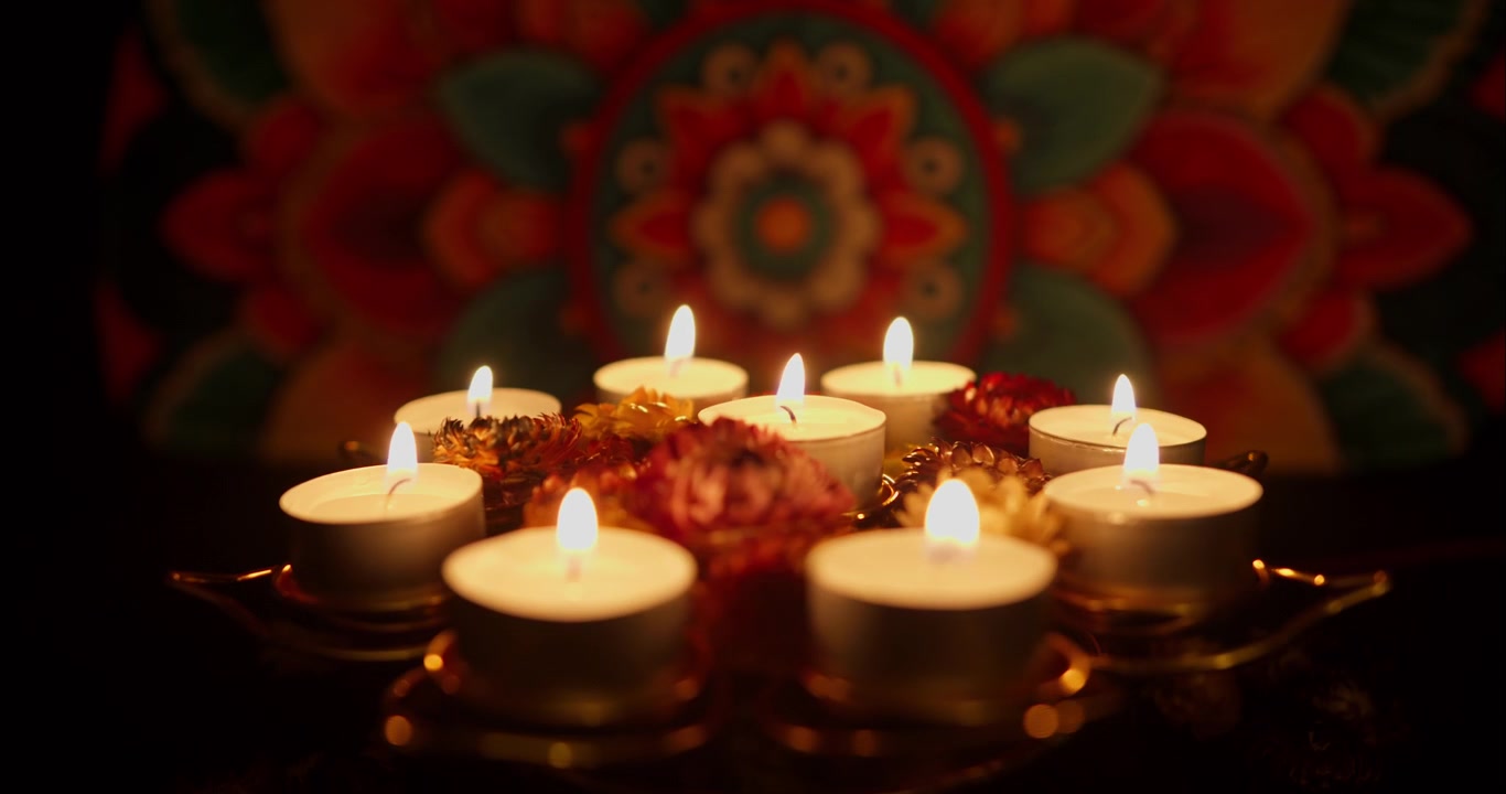 Multiple Tea Light Candles Extinguishing in a Dark Setting