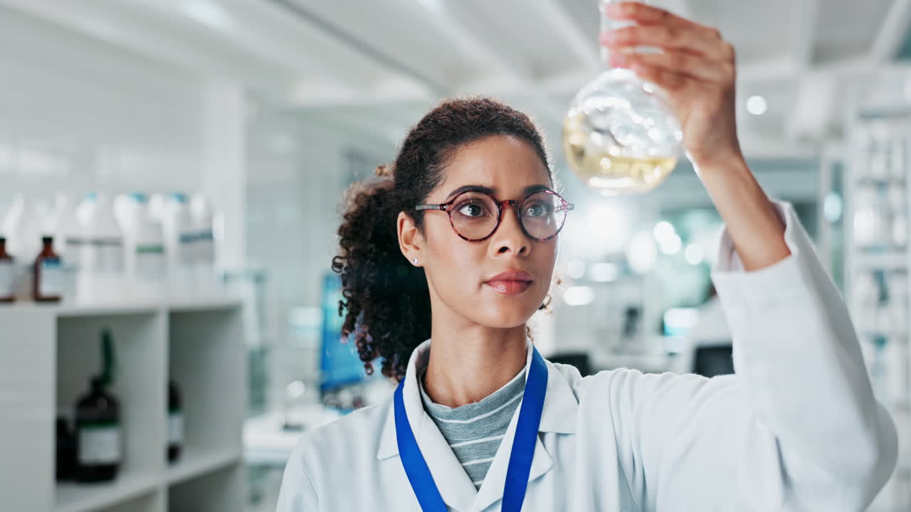 Scientist examining a flask in a lab