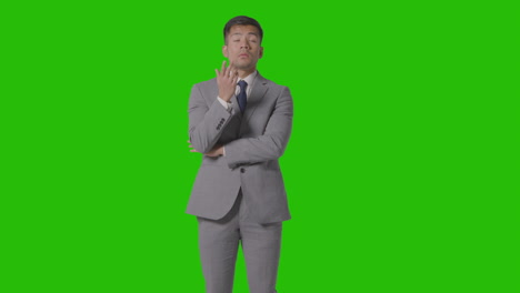 three quarter length shot of serious businessman in suit thinking against green screen 3