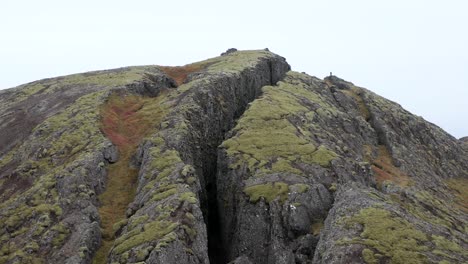 flying away from fissure entrance of lambafellsgjá revealing open wilderness