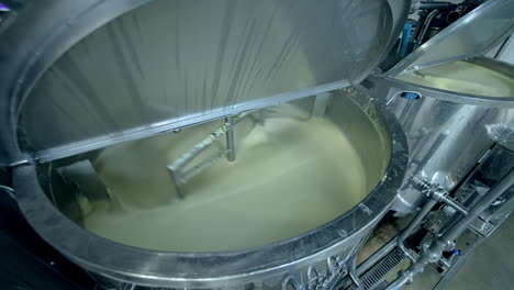 industrial equipment for making butter. modern container mixing butter at milk factory. creamy dairy product in a tank