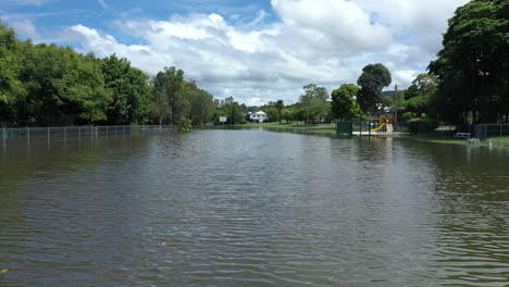 4k-Drone-shot-over-a-flooded-neighborhood-and-road-in-the-town-Murwillumbah,-Australia