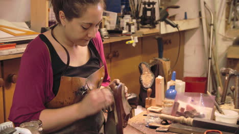 bespoke shoemaker staining and polishing leather of shoe