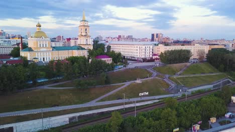 aerial view of a city park with historical buildings at dusk