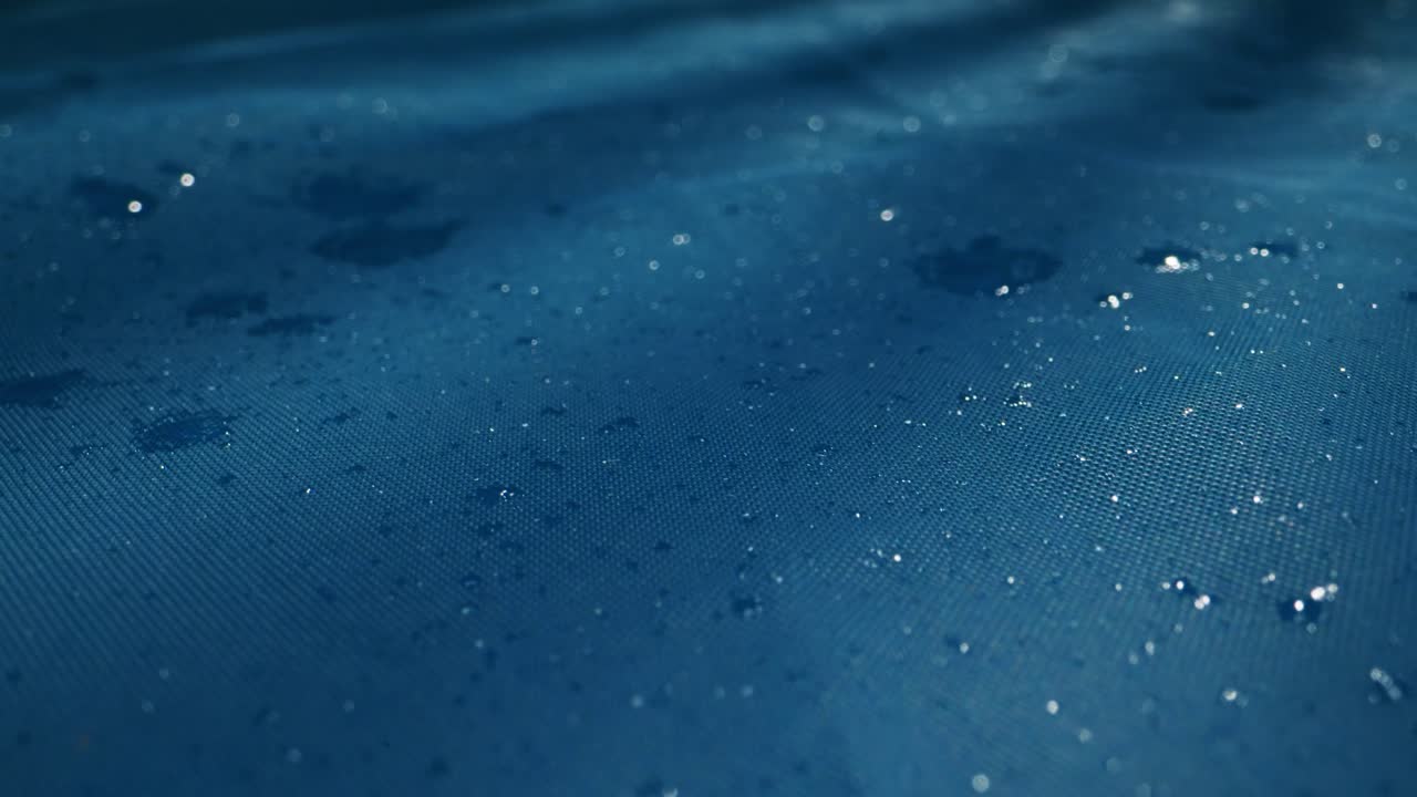 A serene water surface with gentle ripples and glistening raindrops in calming blue hues, creating peace