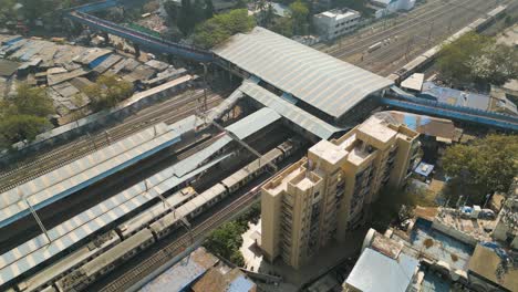 Mumbai-train-transport,-drone-flyover-shot,-train-travel-in-india